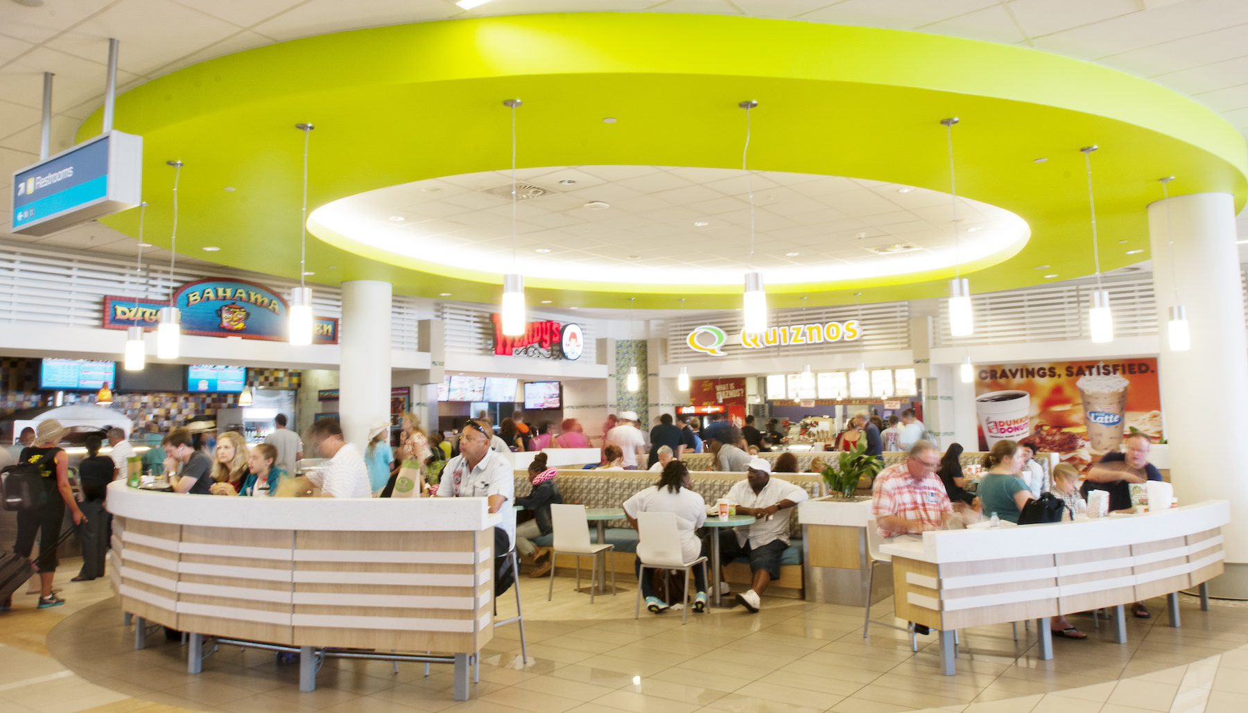 Food court with passengers enjoying meals before their flights