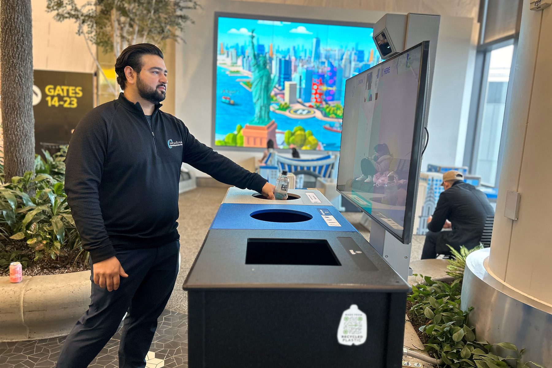 Person using trash can at airport