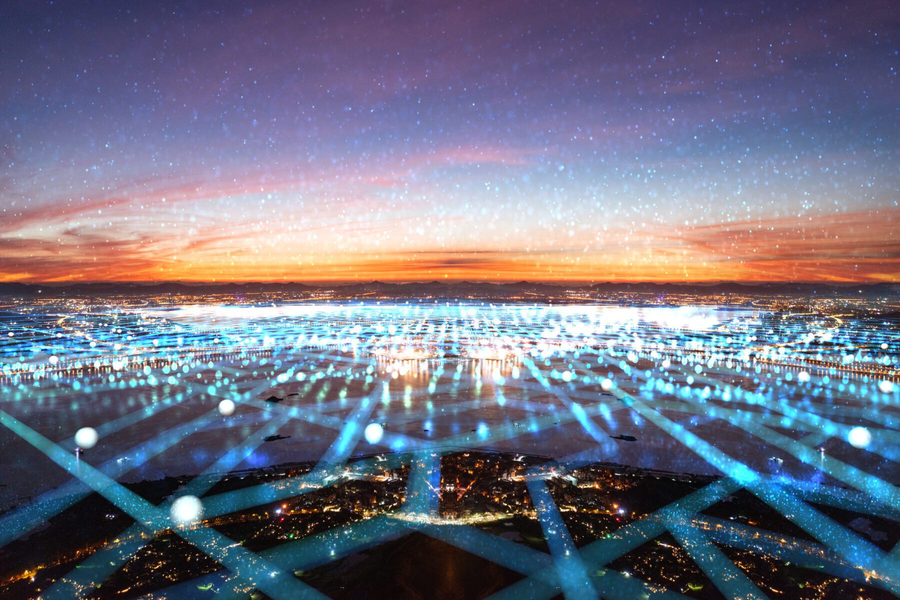 An abstract image depicting a cityscape overlaid with a digital network pattern under a colorful evening sky, suggesting a concept of global connectivity and technology.