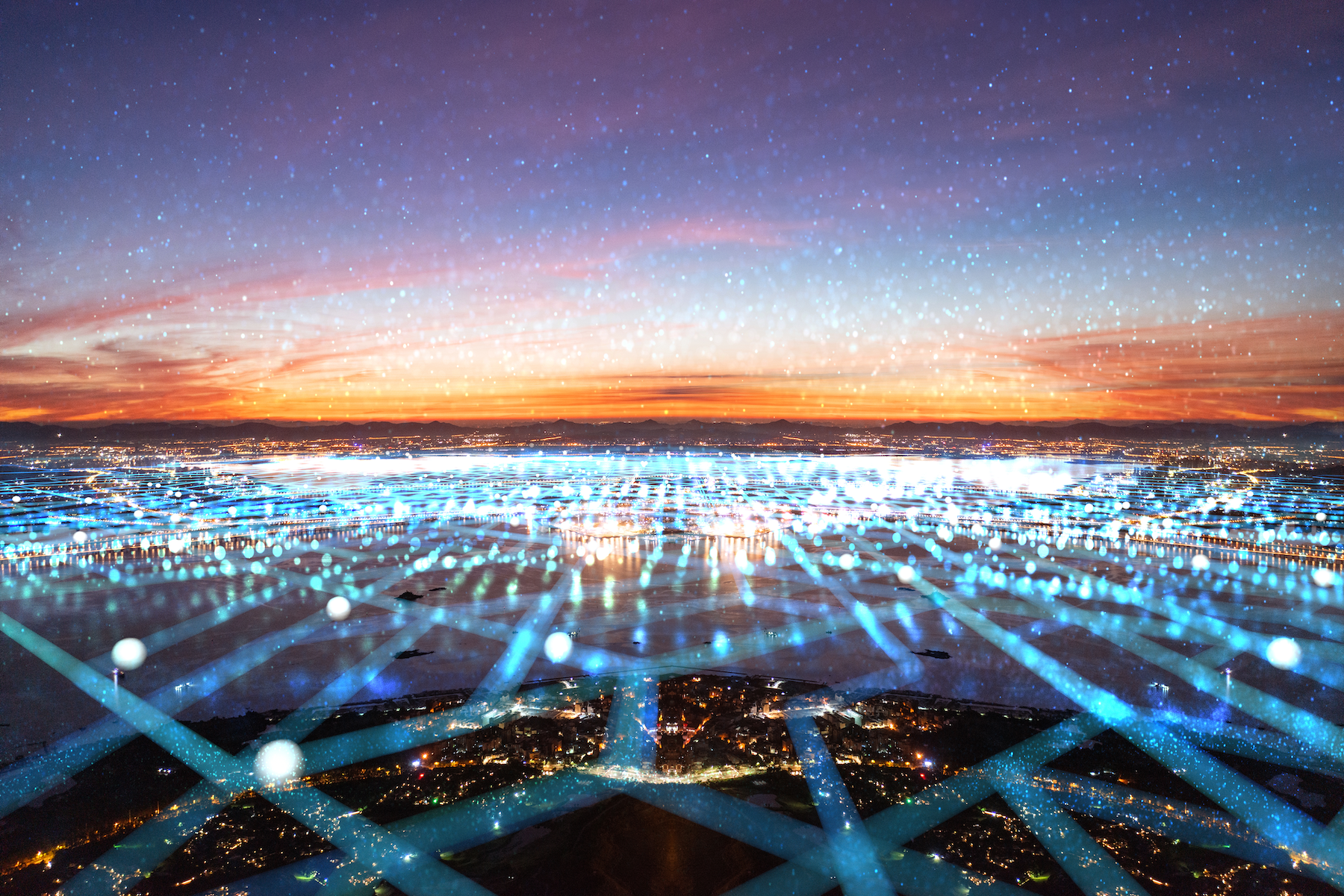 City skyline at dusk overlaid with digital network grid and glowing blue nodes, suggesting high-tech connectivity.